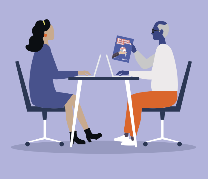 Two people at a desk, one holding the Charter document